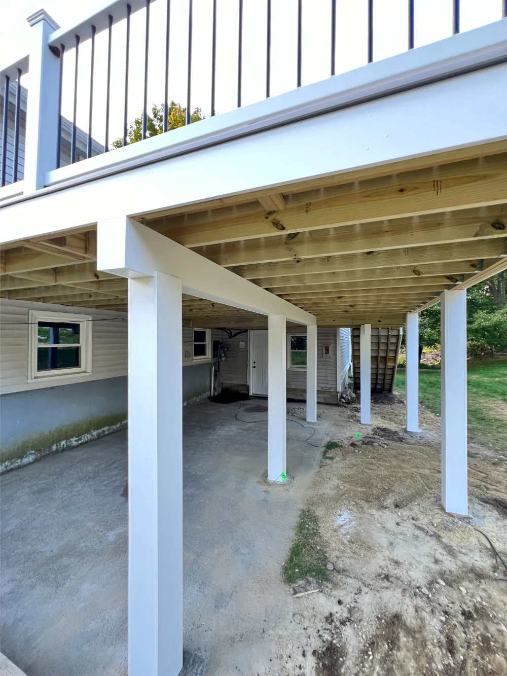 wooden-deck-framing-with-white-railing-in-bolton-ma